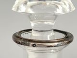 a glass bottle with a ring on top of it