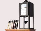 an image of a wine dispenser with a glass of wine next to it