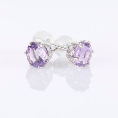 a pair of earrings with amethorate stones on a white background