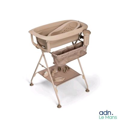 a baby changing table with a baby in it
