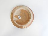 a brown bowl with a tag on it on a white surface