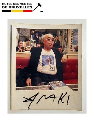 a picture of a man sitting at a table with a drink in front of him