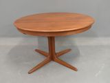 an image of a round wooden table with four legs and a wooden top