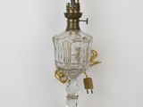 an old fashioned oil lamp with a glass base and gold trimming