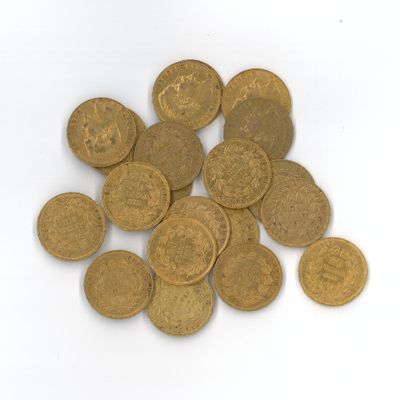 quelques pièces d'or sont éparpillées sur une surface blanche