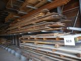 several stacks of wood are stacked on top of each other in a warehouse