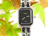 a close up of a watch with a chain around it