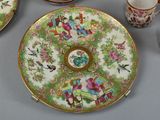 a plate with a flower design on it and cups and saucers