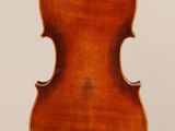 an antique violin with a wooden back and a wooden bow