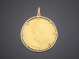 a gold coin pendant with a portrait of a woman