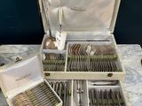 a lot of silverware in a box on a table
