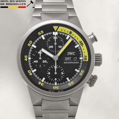 a silver watch with a black face and a yellow second hand