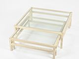 glass coffee table with wooden legs and a glass top on a white background