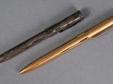 two pens sitting next to each other on top of a table