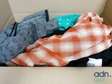 a cardboard box with clothes in it and a tag on it