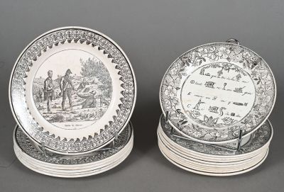 two black and white plates with a picture of a man and a woman on them