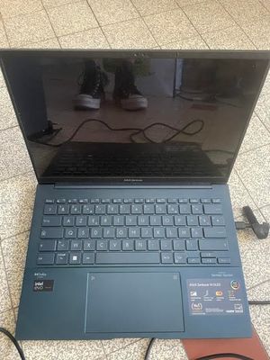 an open laptop computer sitting on top of a tiled floor