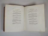 an open book on a table with a white background