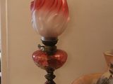 a vase and a lamp on a table in a room