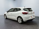 the rear end of a white car parked in a garage