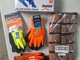 a box of gloves, gloves, gloves, and other items on a table