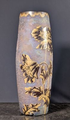 a vase that is sitting on a table in front of a wall