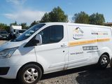 a white van that is parked in a parking lot