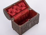 a small metal box with a red velvet lining