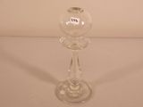 a clear glass candle holder on a white table