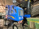 a blue tractor parked inside of a building