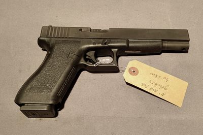 the gun is next to a tag on the table