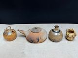 three different types of teapots on a table with a black background