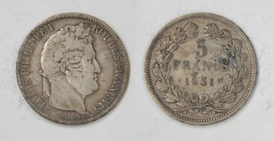 two silver coins, one with a crown and the other with a crown on it