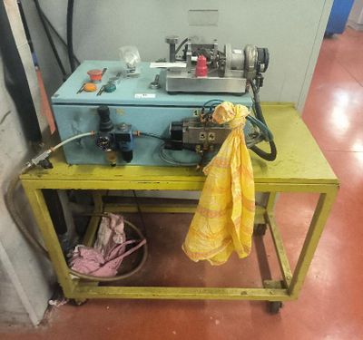 a yellow table with a blue machine on it