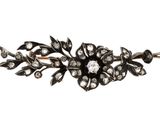 a close up of a black and white flower broochle