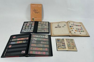 an open book sitting on top of a white table next to a pile of stamps