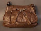 brown leather purse with chain and tassels hanging from it ' s side