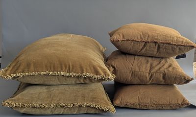 several pillows are stacked on top of each other on a table