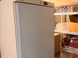 a refrigerator that is in the middle of a kitchen