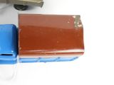 a toy train and a suitcase on a white surface