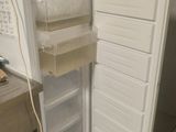 a white refrigerator with its door open in a kitchen