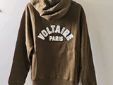 hoodie with the word voltaire paris on it hanging on a hanger
