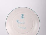 a white plate with a blue anchor on it