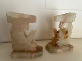 two figurines of a man and a woman sitting on a table