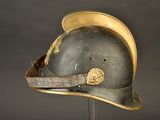 an old helmet on a stand on a black background