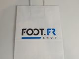 the bag is white with blue and black logos on it