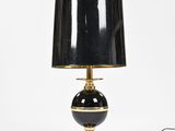 a black and gold table lamp with a black shade