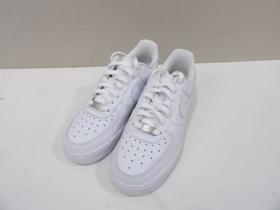 a pair of white sneakers on a white surface