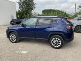 the blue jeep compass is parked in a parking lot
