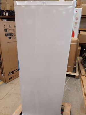 a white refrigerator sitting on a pallet in a warehouse